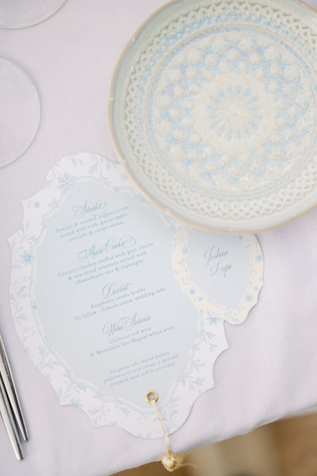 Menu and place card on a blue-patterned plate